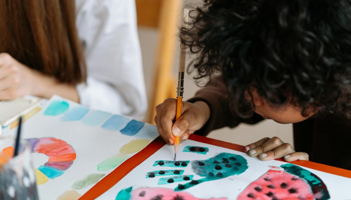 little boy drawing and painting watermelons